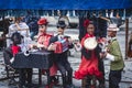 View of street puppet show theatre, with puppeteer puppet master pulling the strings over marionette dolls Royalty Free Stock Photo