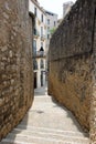 View of the street between the two walls in the Jewish quarter of Girona, Spain. Royalty Free Stock Photo