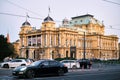 View of streetlife with architecture, vehicles, and locals in Zagreb, Croatia