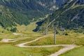 View of a strong curving mountain road cut by a disused ski lift