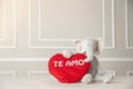 View of a stuffed elephant holding a heart with Te Amo writing on it - valentine's concept