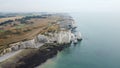 View of the stunning coastline featuring white cliffs of Etretat on a foggy day