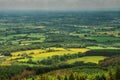 View on a stunning country side from a top of a hill, Green forest and fields and blue cloudy sky. County Tipperary, Ireland.