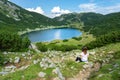 View stunning zireiner see lake in tyrol alm mountins austria with a woman sitting Royalty Free Stock Photo