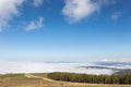 View of Subasio mountain Umbria over valley filled by fog, and beneath a blue sky with white clouds Royalty Free Stock Photo