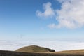 View of Subasio mountain Umbria over valley filled by fog and beneath a wide, blue sky with white clouds Royalty Free Stock Photo