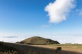 View of Subasio mountain Umbria over valley filled by fog, and beneath a wide sky with white clouds Royalty Free Stock Photo