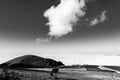 View of Subasio mountain Umbria over valley filled by fog, and beneath a wide sky with white clouds Royalty Free Stock Photo