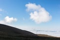 View of Subasio mountain Umbria over valley filled by fog, and beneath a wide sky with white clouds Royalty Free Stock Photo