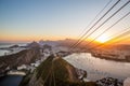 View from Sugarloaf mountain in Rio de Janeiro at sunset overlooking Guanabara Bay with sun setting behind mountains Royalty Free Stock Photo