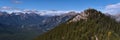 View of Sulphur Mountain peak with wooden boardwalk between trees in Banff National Park, Alberta, Canada. Royalty Free Stock Photo