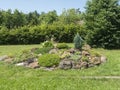 View on summer garden with beautiful rock garden with various alpine, rock plants, decorative grass and conifers and many other Royalty Free Stock Photo