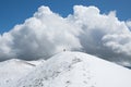 View of the summit of Monte Calvo against a big cloud and blue sky Royalty Free Stock Photo