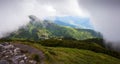 View of the sun through the clouds in mountains