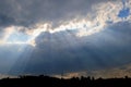 VIEW OF SUN RAYS EMANATING FROM BEHIND CLOUDS Royalty Free Stock Photo