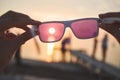 View of the sun, sea and sky through pink sunglasses Royalty Free Stock Photo