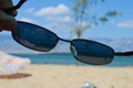 View on sunny beach through dioptric sunglasses with UV 400 filter Royalty Free Stock Photo