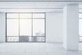 View on sunny city from big window in modern spacious light room with white wall and ceramic tales floor Royalty Free Stock Photo