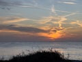 A view of a Sunset on the beach at Siesta Key, Florida with a blue cloudy sky Royalty Free Stock Photo