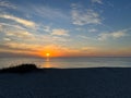 A view of a Sunset on the beach at Siesta Key, Florida with a blue cloudy sky Royalty Free Stock Photo