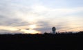 View of the sunset behind the old water reservoir tower. Royalty Free Stock Photo