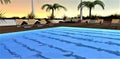 View of the sunset from the illuminated pool. Stkpeni are visible under the clear blue water. Several beige sun loungers on