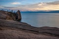 View at sunset from the island of Olkhon on Lake Baikal to the cape, water and mountains behind the lake