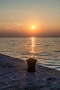 A view at sunset out to sea from the harbour breakwater in the town of Izola, Slovenia Royalty Free Stock Photo