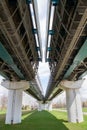 View of the supports and metal spans of the light metro on a clear sunny day against the blue sky. Transport railway