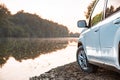view of suv car at river beach on sunset Royalty Free Stock Photo