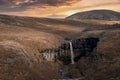 View of Svartifoss waterfall amidst basalt columns and cliffs during sunset Royalty Free Stock Photo
