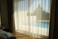 View of swimming pool through hotel window. Royalty Free Stock Photo