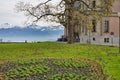 View of the Swiss Alps from the lawn of Schadau Castle with Lake Thun Thunersee in foreground Royalty Free Stock Photo