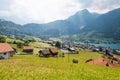 View of swiss village Lungern with traditional houses along the lake Lungerersee, canton of Obwalden, Switzerland Royalty Free Stock Photo