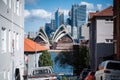 View of the Sydney opera house from Kirribilli against skilines on a sunny day with a bright sky