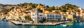 View on Symi Simi island harbor port, classical ship yachts, houses on island hills, Aegean Sea bay. Greece islands holidays