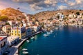 View on Symi (Simi) island harbor port, classical ship yachts, houses on island hills, Aegean Sea bay. .