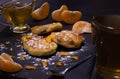 View of Syrniki with raisins and tangerines, covered with icing sugar. Nearby is fresh honey from a sunflower and a cup of tea.