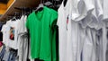 View of t-shirts hanging on hangers in a clothing store Royalty Free Stock Photo