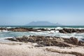 View of Table Mountain with beach, ocean and rocks in foreground