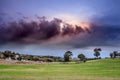 View of  Table Mountain covered in clouds at sunset with a lake and green lawn in foreground, Cape Town Royalty Free Stock Photo