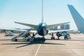 View of the tail section of the aircraft. Passenger plane parked at the airport with a gangway. Royalty Free Stock Photo