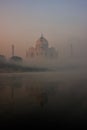 View of Taj Mahal reflected in Yamuna river with early morning f