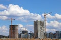 View of tall cranes and houses under construction Royalty Free Stock Photo