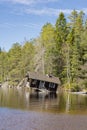 View of Tampaja lake and tilted sauna also known as the Drunken Sauna, Kirkkonummi, Finland