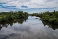 View on Tapee River valley in back lit against storm leaden clouds background