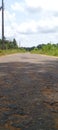 A view of a tarmac road in the morning with the evening sun rising in a rural setting in Sri Lanka. A green vision.