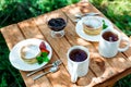 View of tasty pancakes with organic strawberries near cups with tea