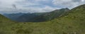 View from tatra mountain trail on Baranec to Western Tatra mountains or Rohace panorama. Grassy meadow hills, blue sky Royalty Free Stock Photo