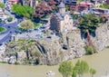 View of Tbilisi city from Narikala Fortress, old town and modern architecture. The Metekhi temple. Georgia